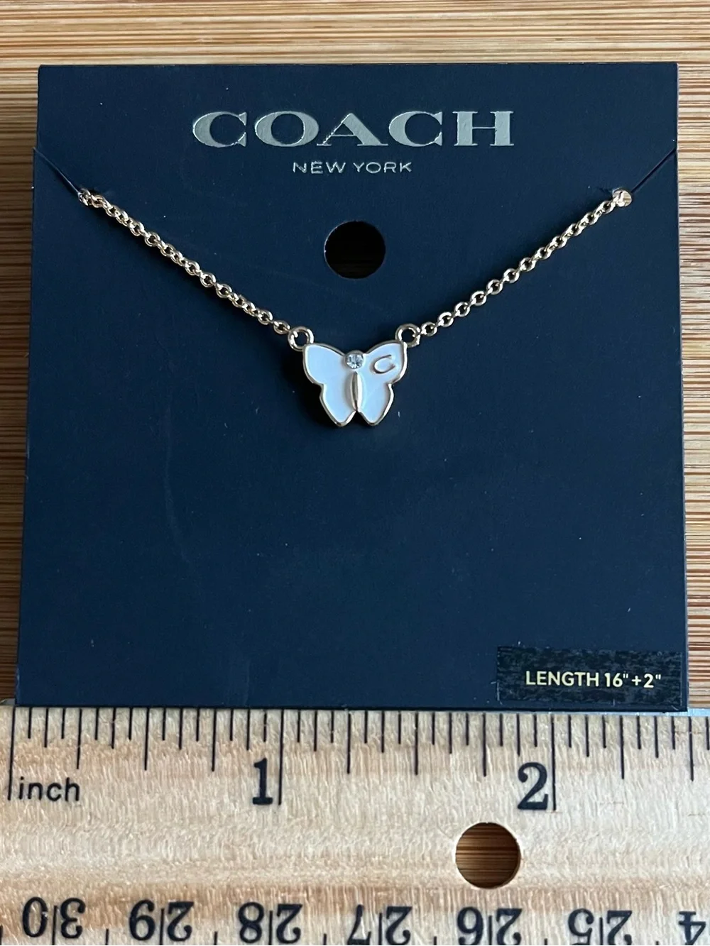 Coach Signature Butterfly Necklace Gold Tone White Enamel w/ a Crystal Accent